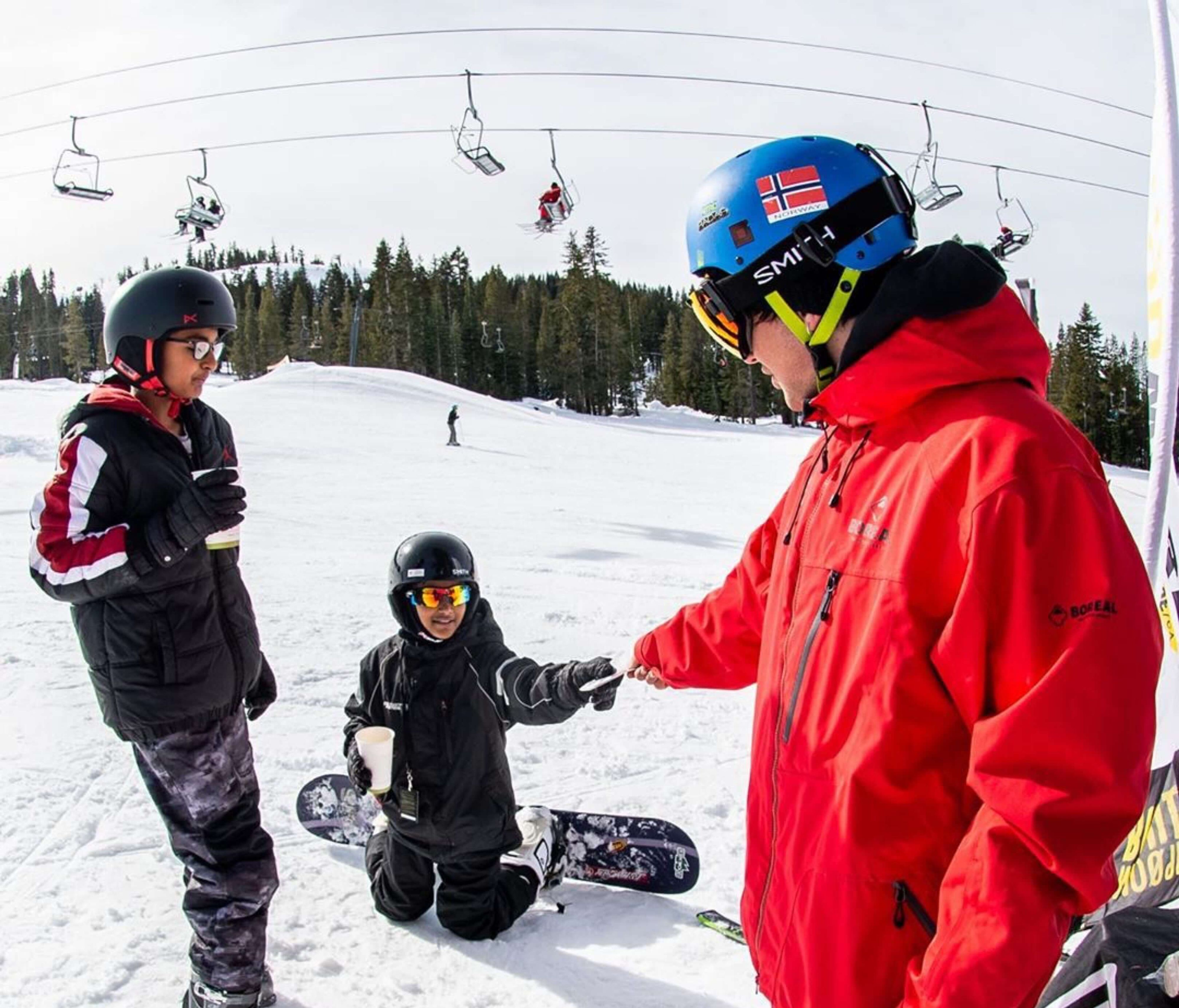 Snowboarded sharing his information with a patroller