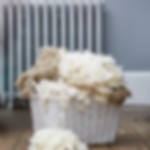 A close-up image of British wool in a white wicker basket.