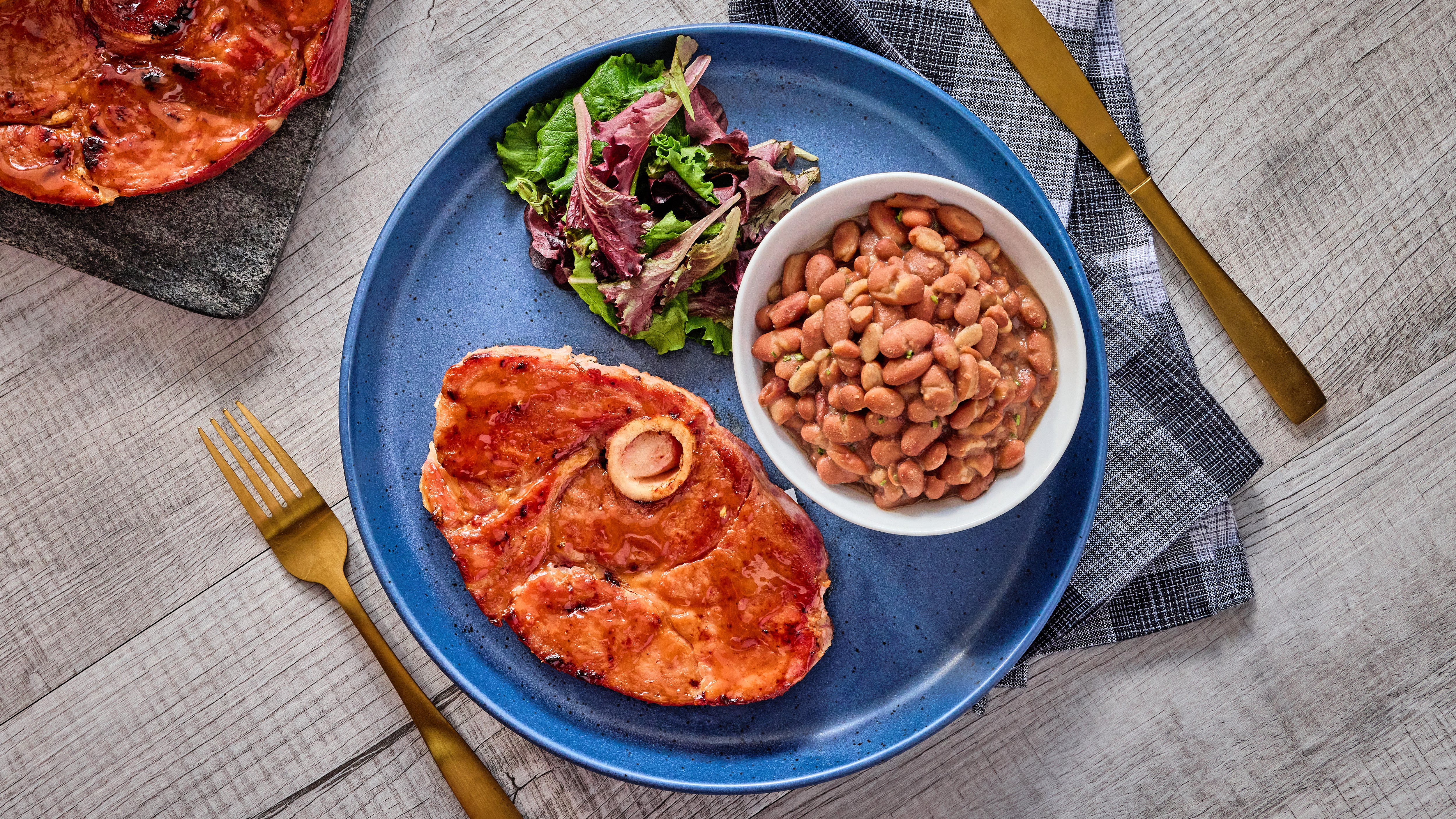 Bone-In Ham Steak with BBQ Brown Sugar Glaze and Spicy Pinto Beans