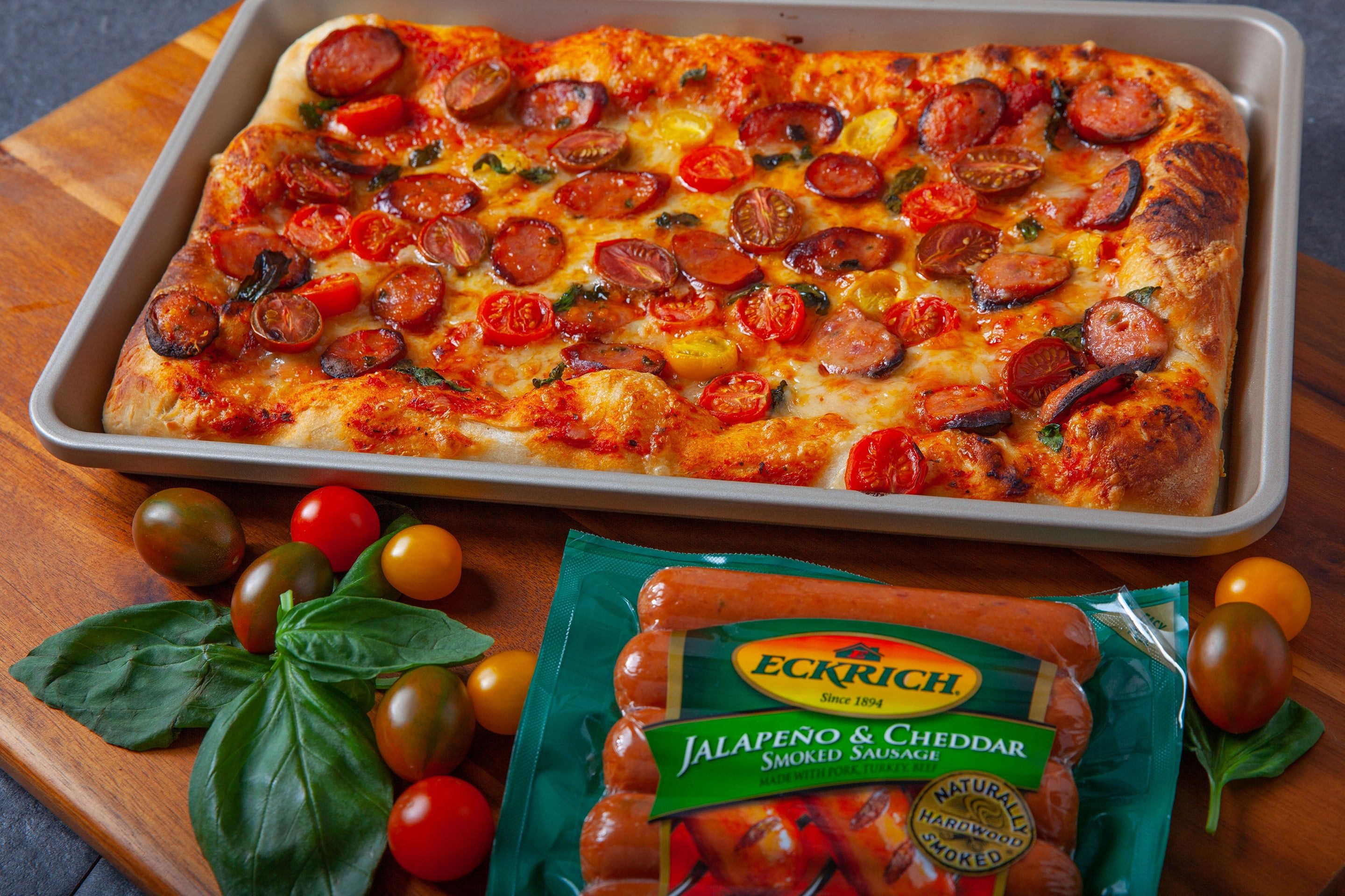 Pizza with smoked sausage, cherry tomatoes, dried chilli, jalapeno