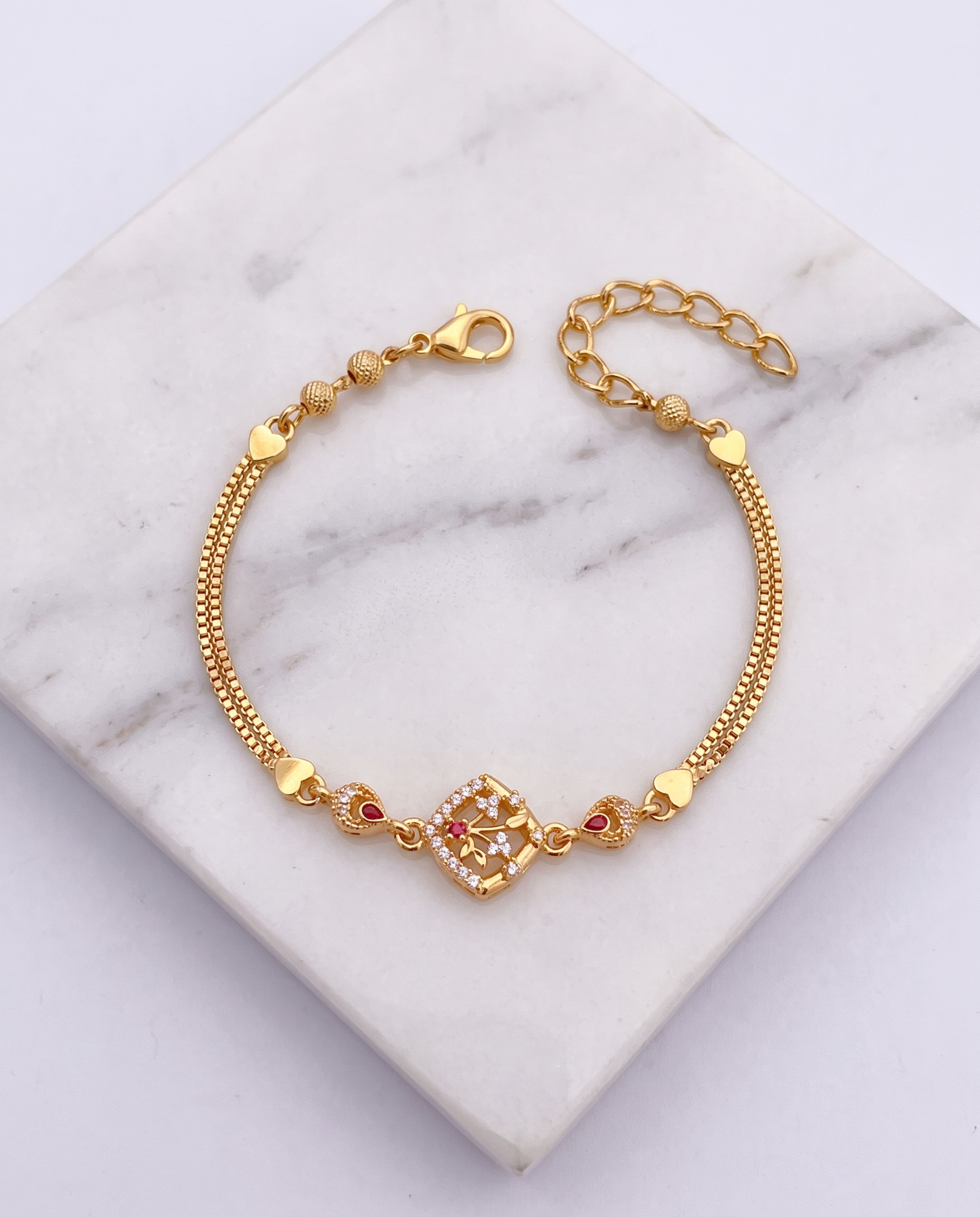 A.D Diamond Golden Bracelet laid on white marble