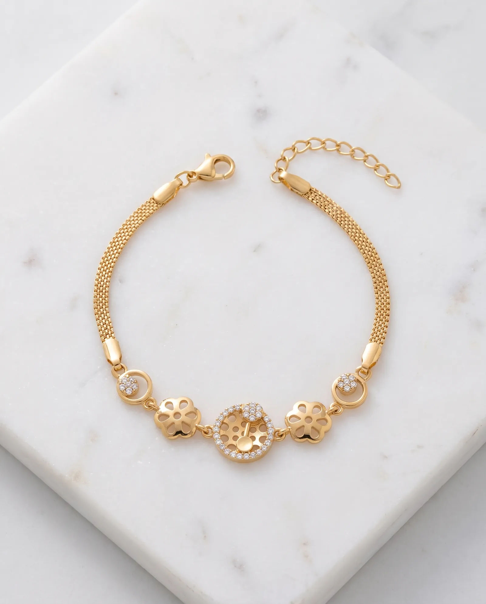 Gold-Tone AD Stone Chain Bracelet laid on white marble