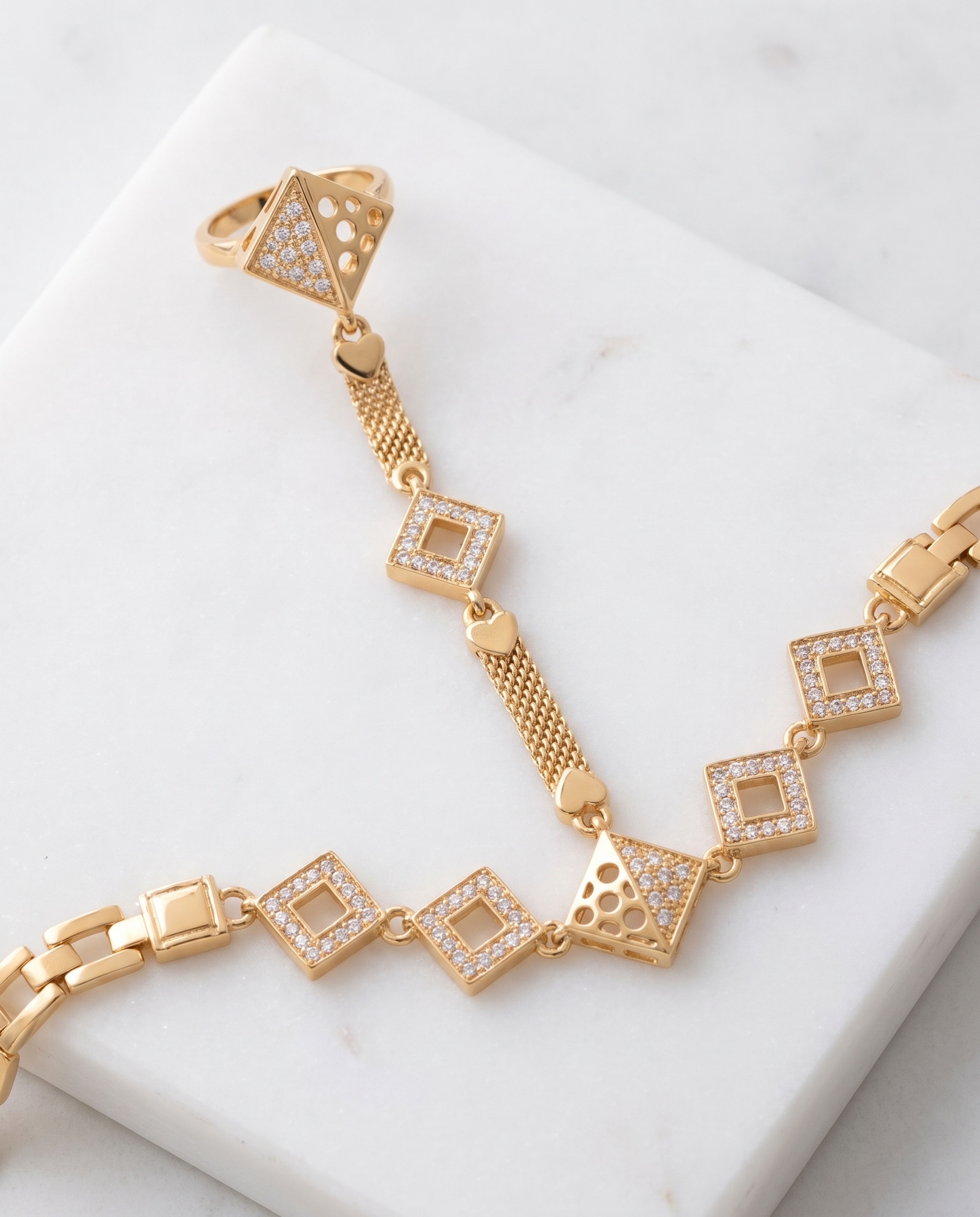 High Gold Ring Bracelet laid on white marble