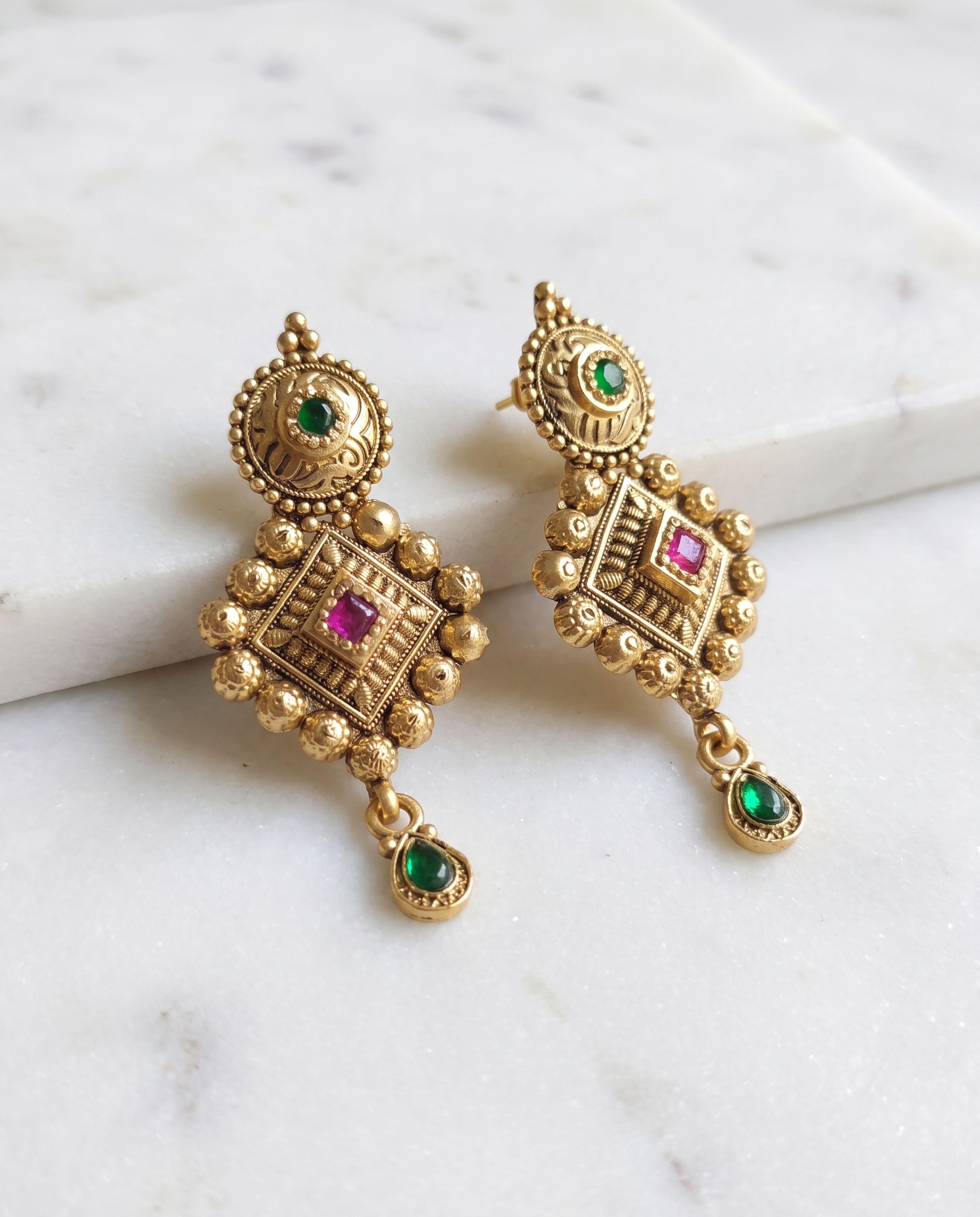 Antique Earring laid on white marble
