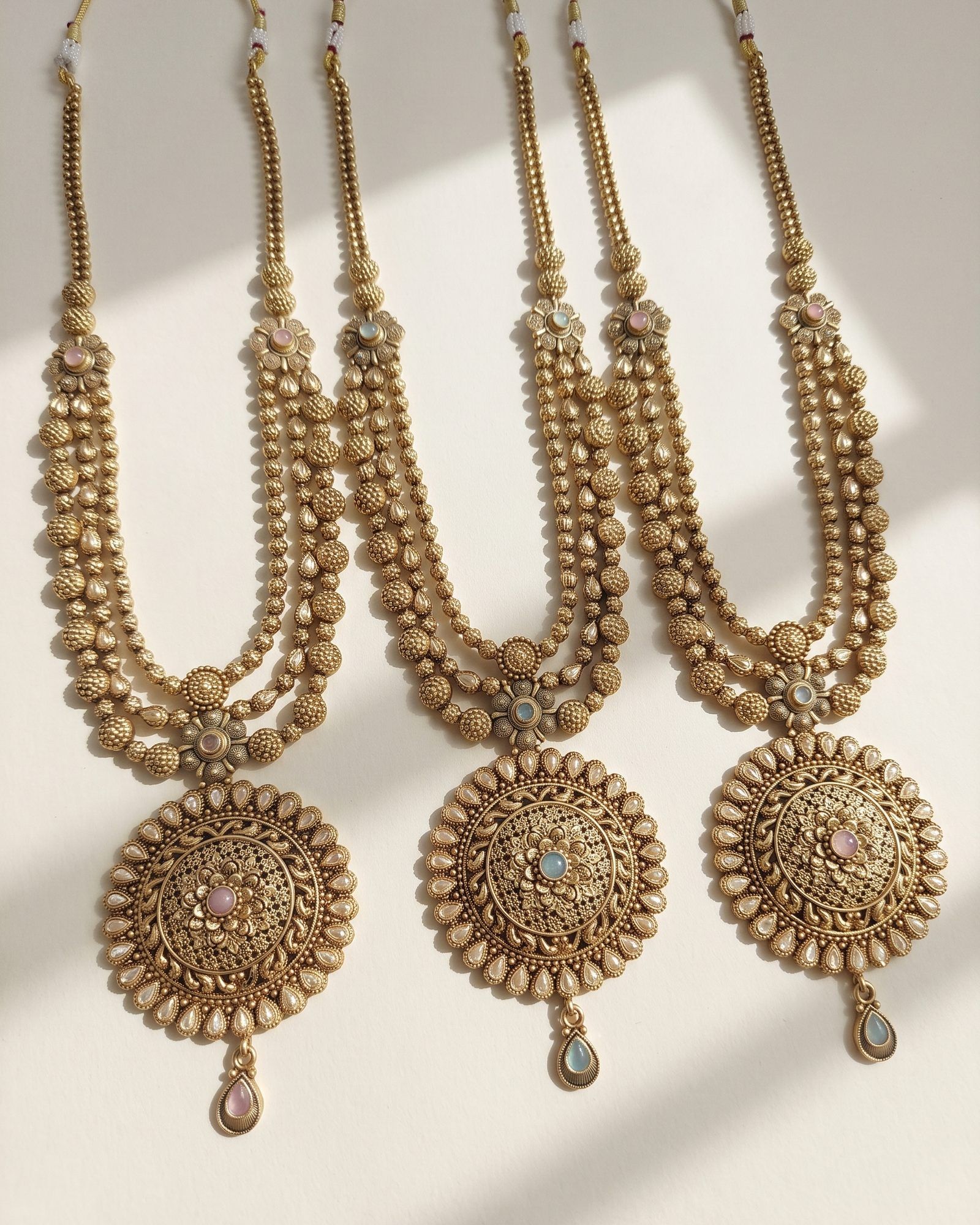 Antique Round Medallion Layered Necklace laid on white marble