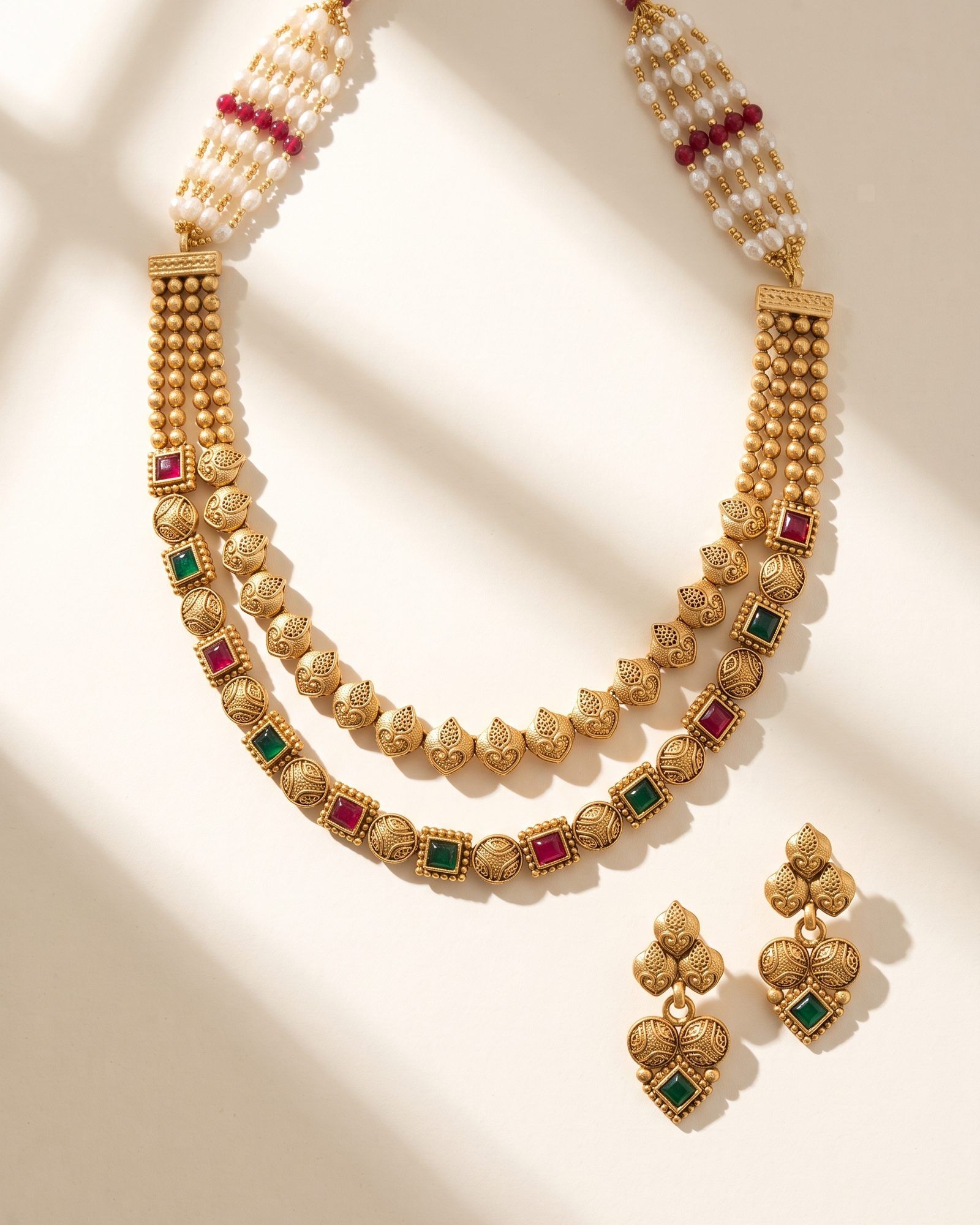 Antique Red Green Stone Layered Necklace laid on white marble