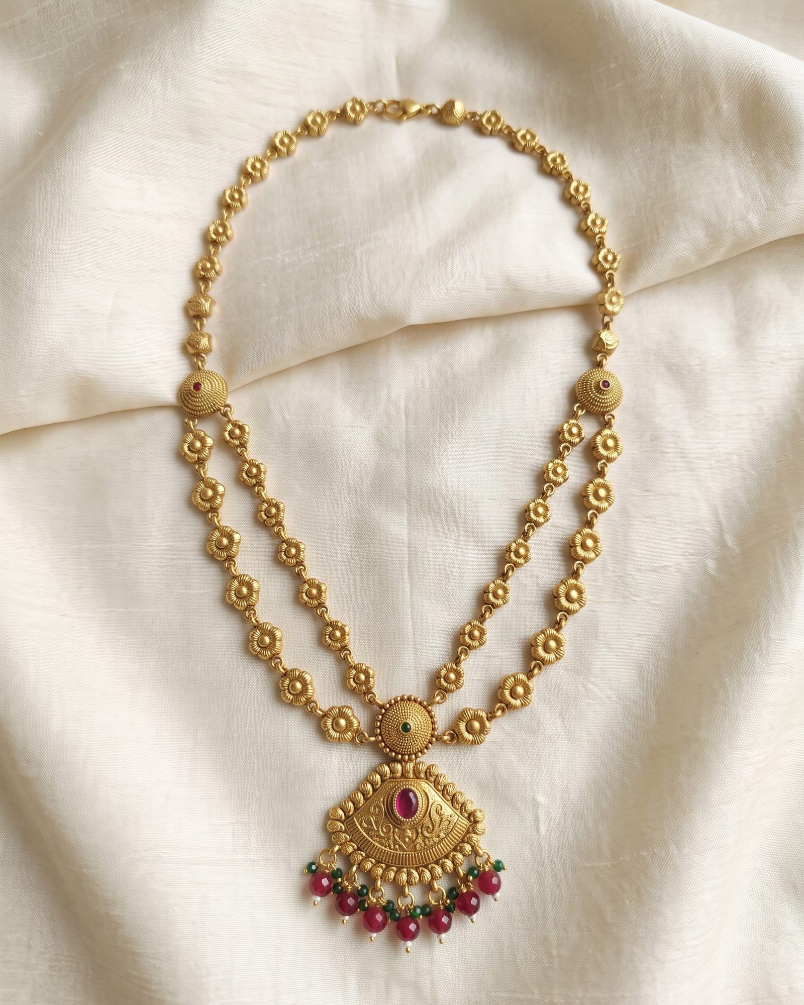 Antique Floral Motif Layered Necklace laid on white marble