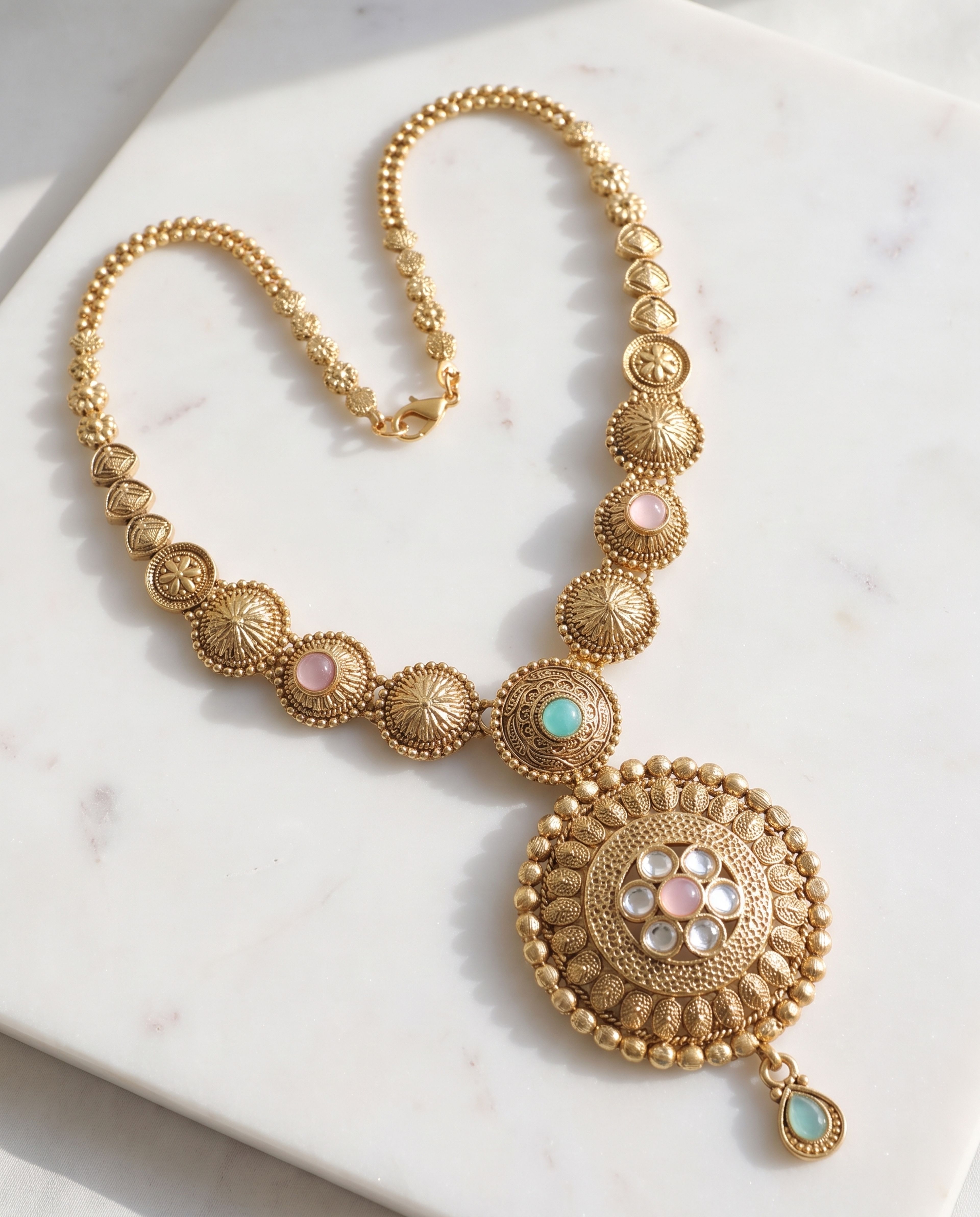 Antique Long Chain with Pink and Aqua Pendant laid on white marble