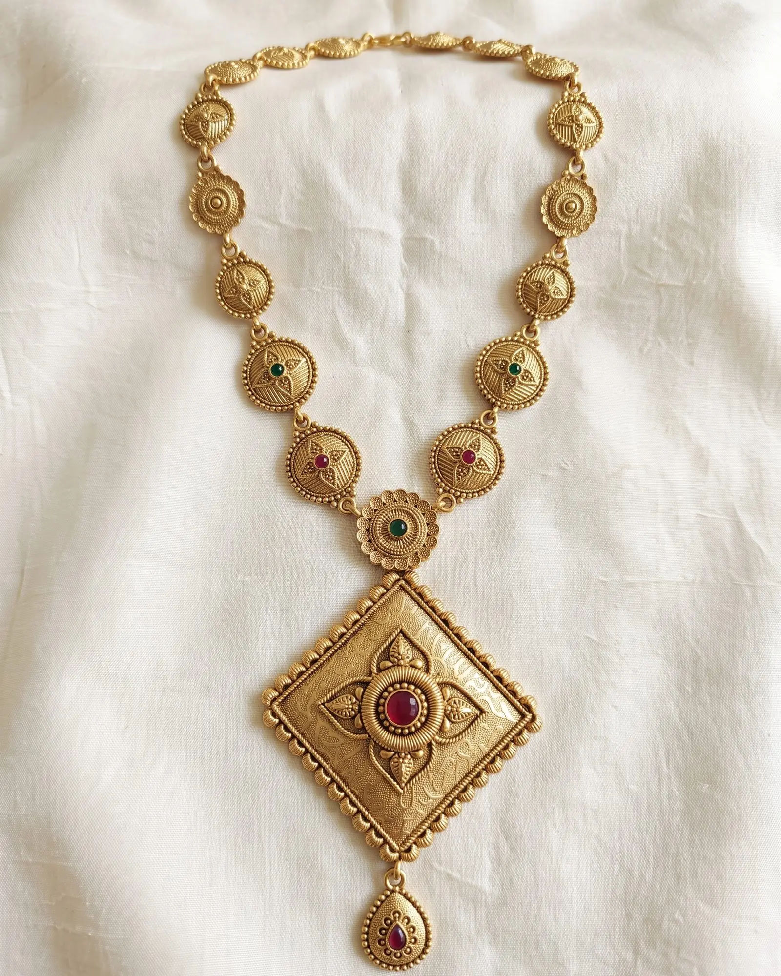 Antique Rhombus Pendant Long Necklace laid on white marble