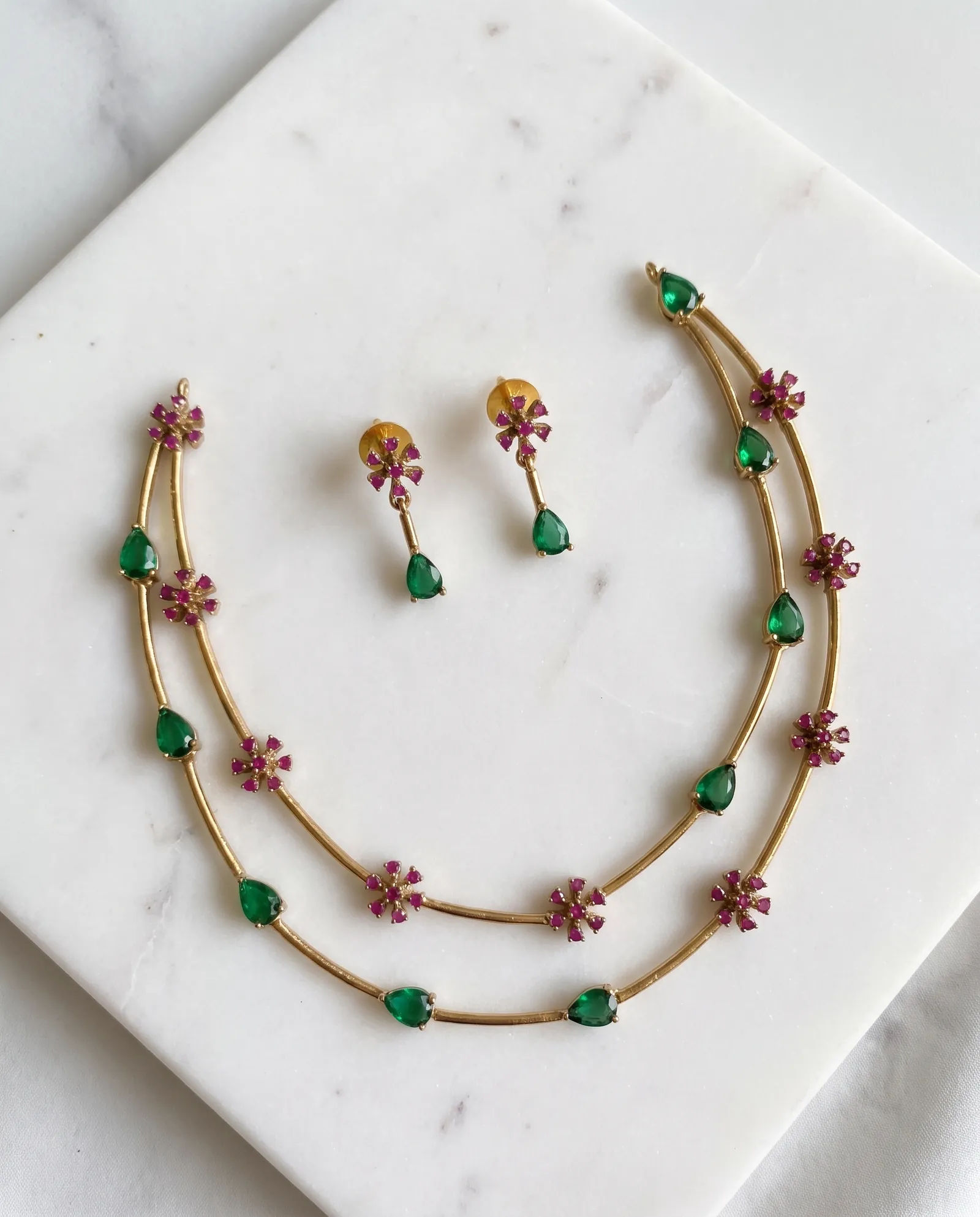 Blossom Emerald Chain laid on white marble
