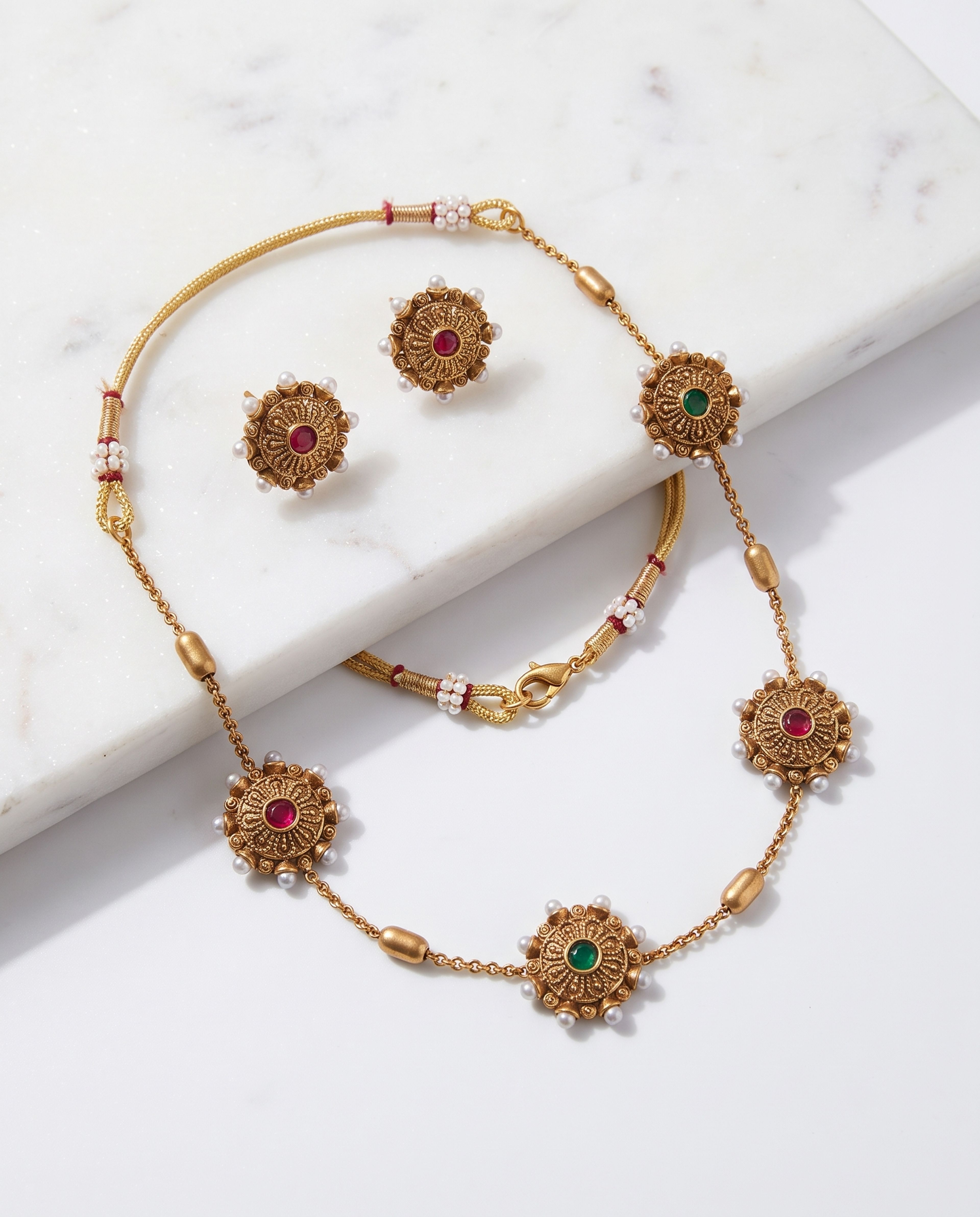 Coin Pearl Necklace Set laid on white marble