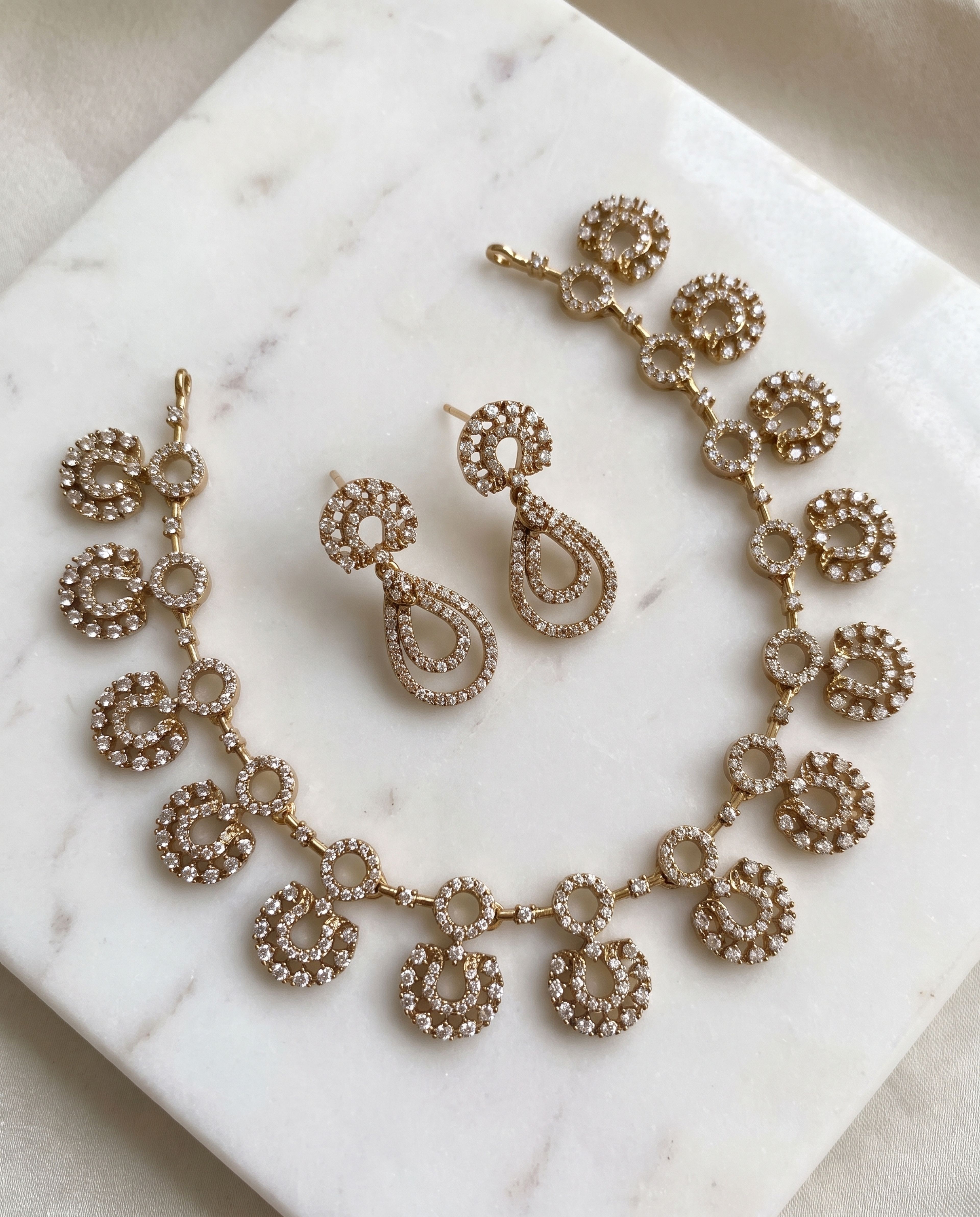 Double Circle Loop Necklace Set laid on white marble