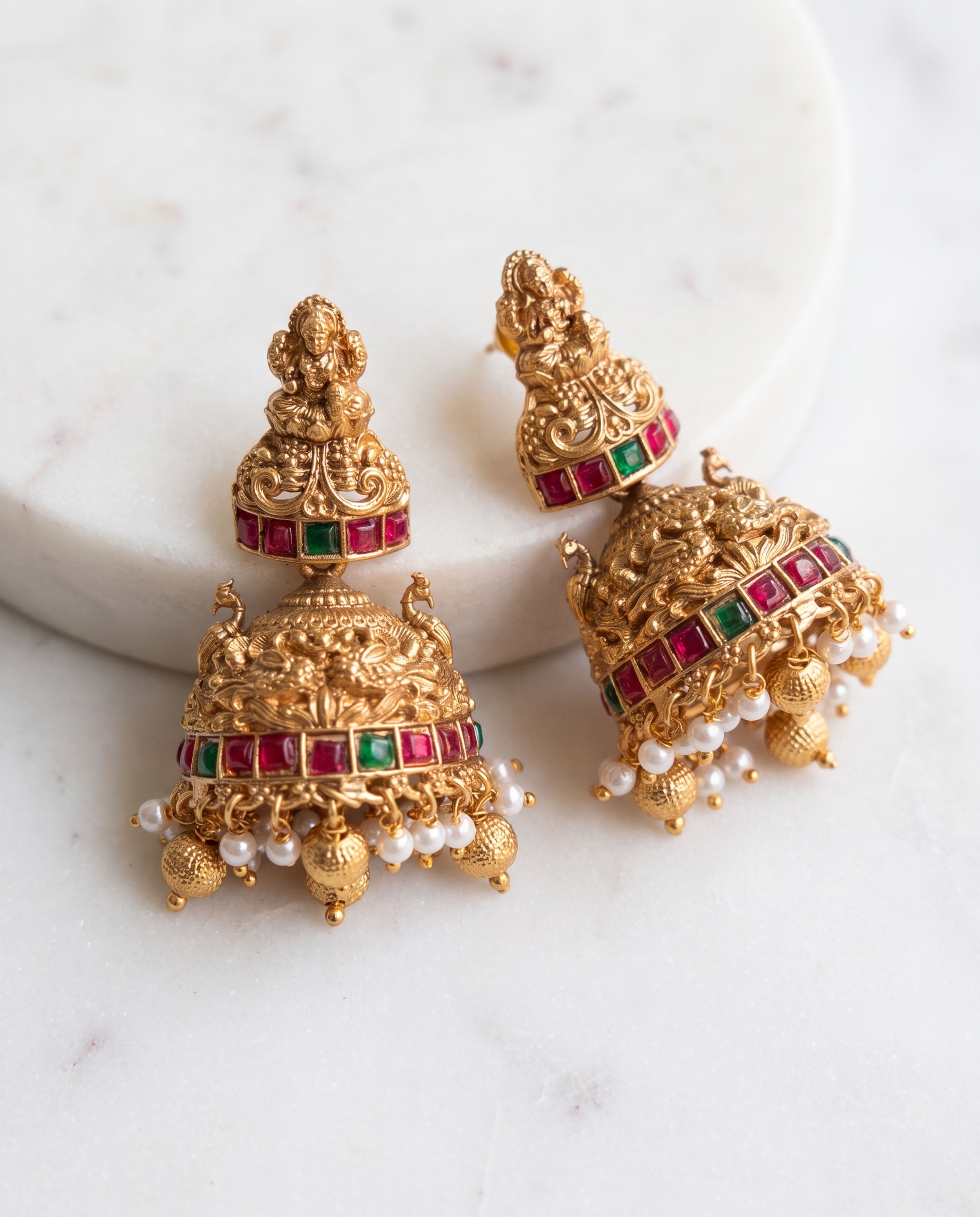 Kemp Jhumkas laid on white marble