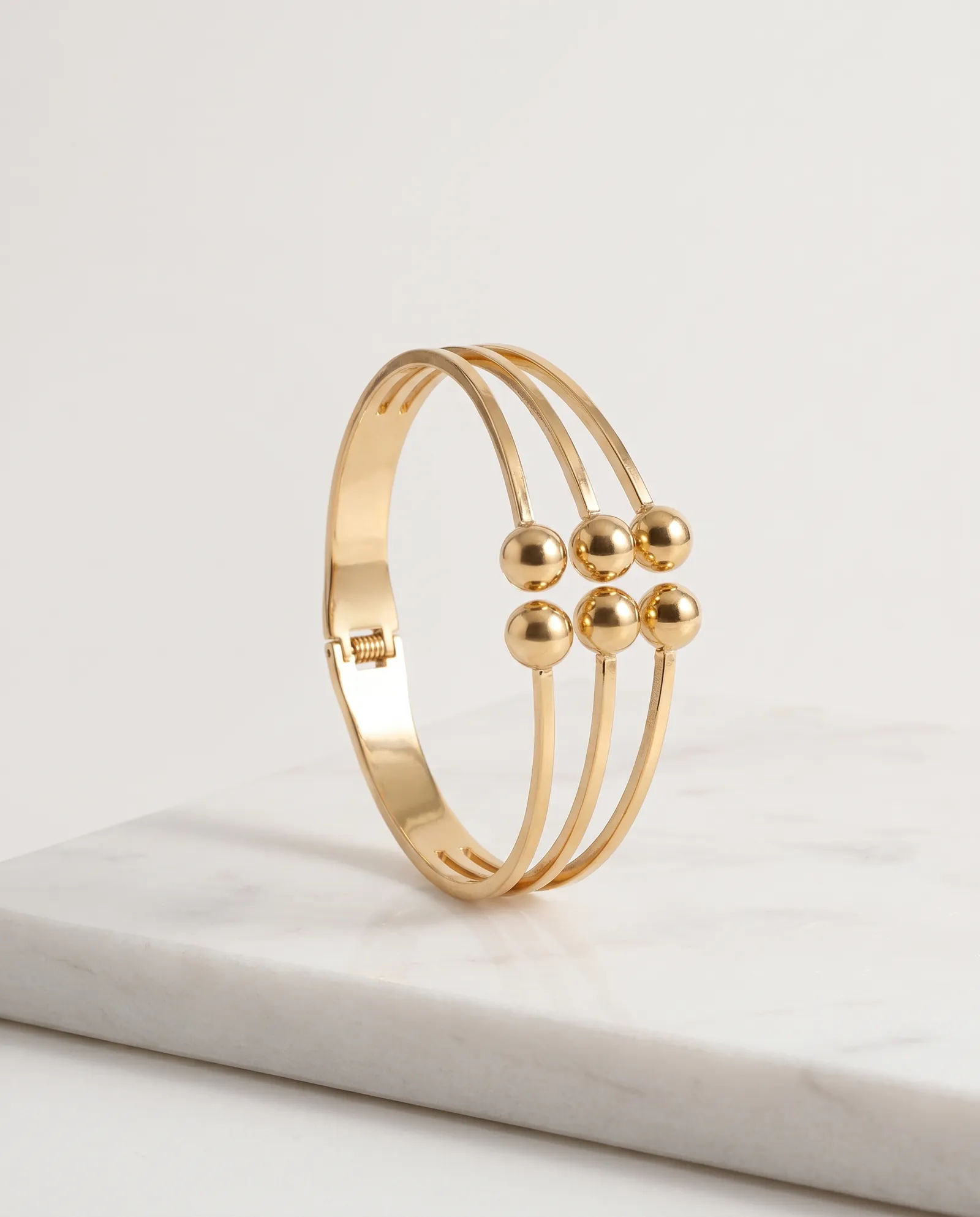 Layered Ball Bangle Anti Tarnish laid on white marble