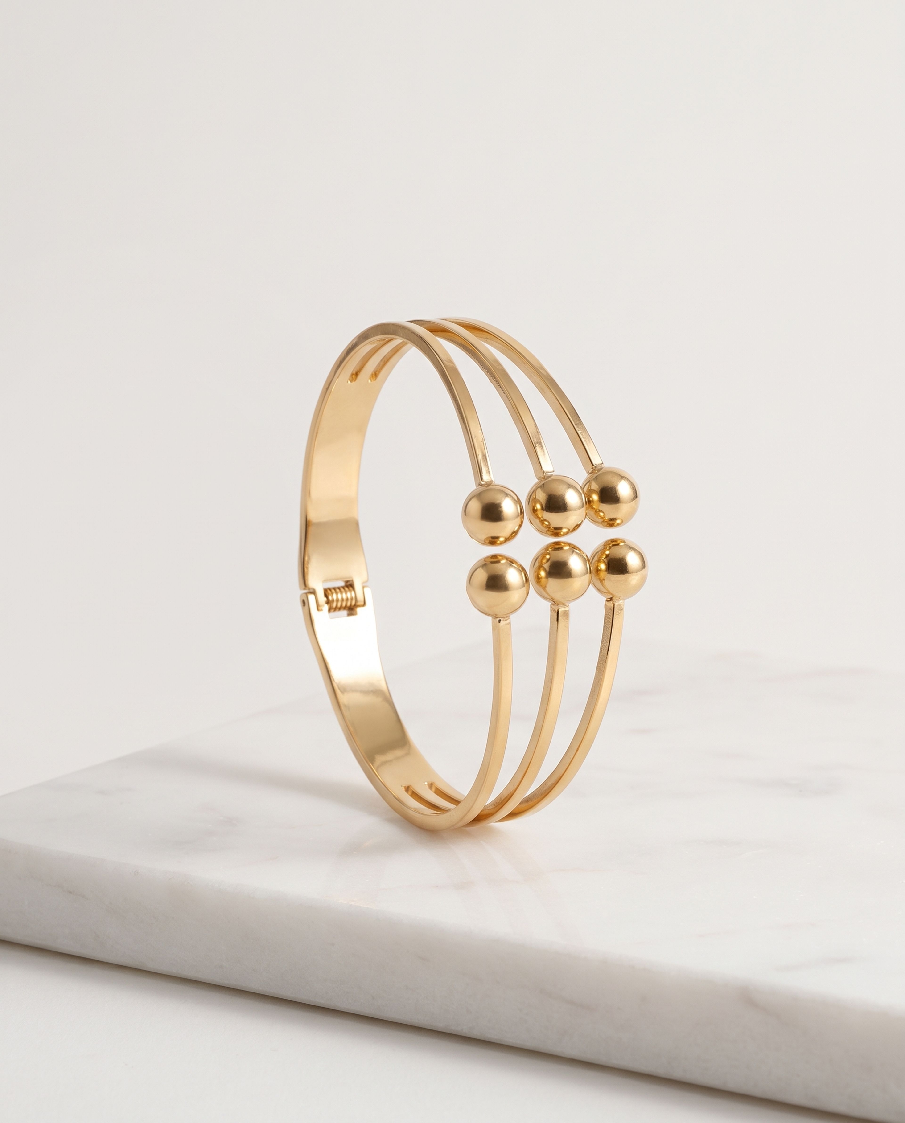 Layered Ball Bangle Anti Tarnish laid on white marble