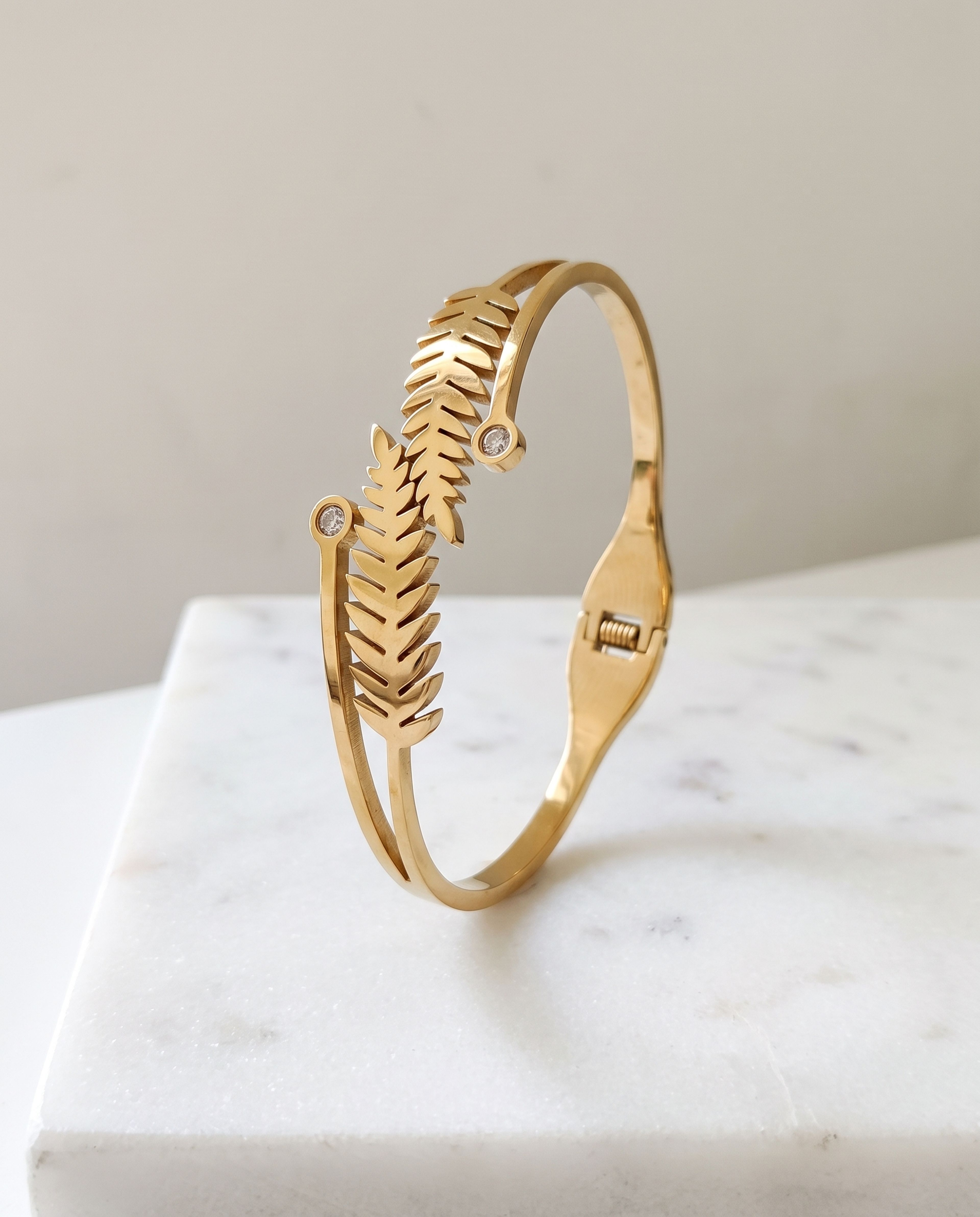 Leaf Bangle Anti Tarnish laid on white marble