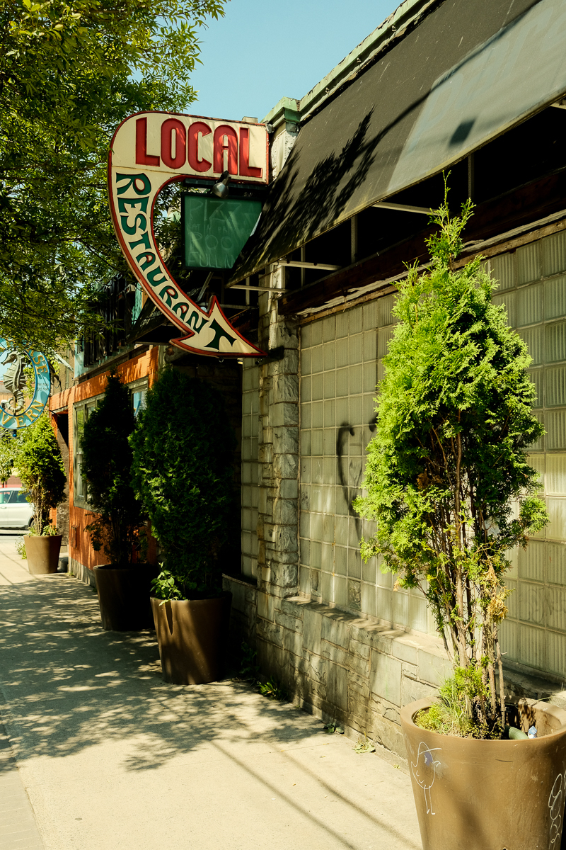 Front of a closed restaurant with retro sign that says local restaurant