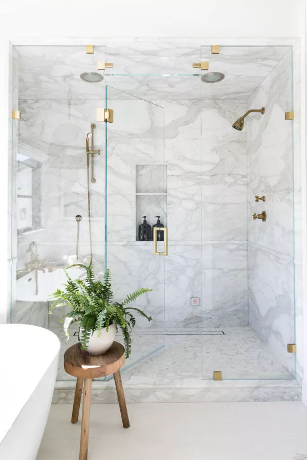 Marble shower with clear door designed by Janelle Randazza