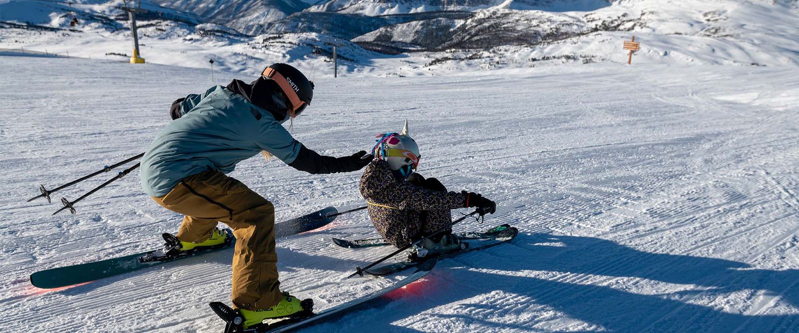 ski-vacation-early-bird-mom-daughter-skiing-banff-sunshine-reuben-krabbe-banner