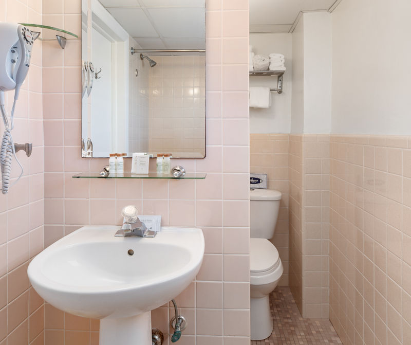 A bathroom with a sink, toilet, and mirror