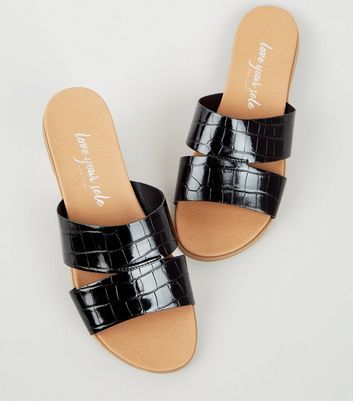 black patent sliders