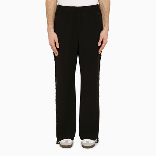 Black track pants with fringes