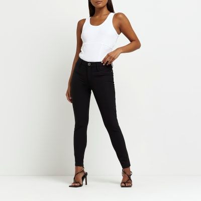 Petite black faux leather skinny trousers  River Island