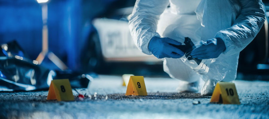 Forensics Specialists Starting to Pack Evidence on Crime Scene After a Tragic Ending of a Violent Gun Fire Exchange Between Gang Members. Empty Handgun is the Murder Weapon Used to Shoot the Victims