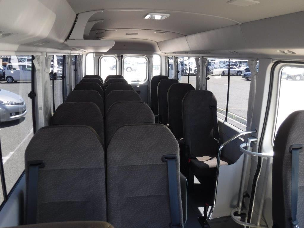 Toyota Coaster interior — wide comfortable seats with ample legroom