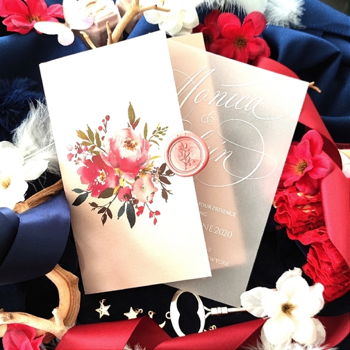 This photo shows two invitation styles.  There is a pocket fold blush invitation card with a blush wax seal as well as a vellum UV printed flat single card. This photo shows two invitation styles.  There is a pocket fold blush invitation card with a blush wax seal as well as a vellum UV printed flat single card.