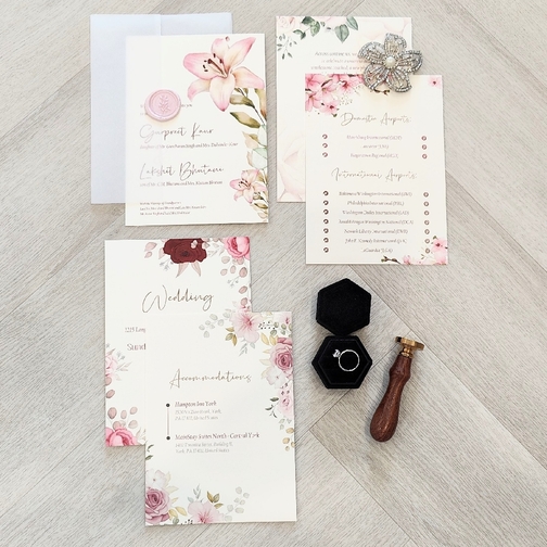 Multiple inserts into a vellum wrap enclosure and pink wax seal design.