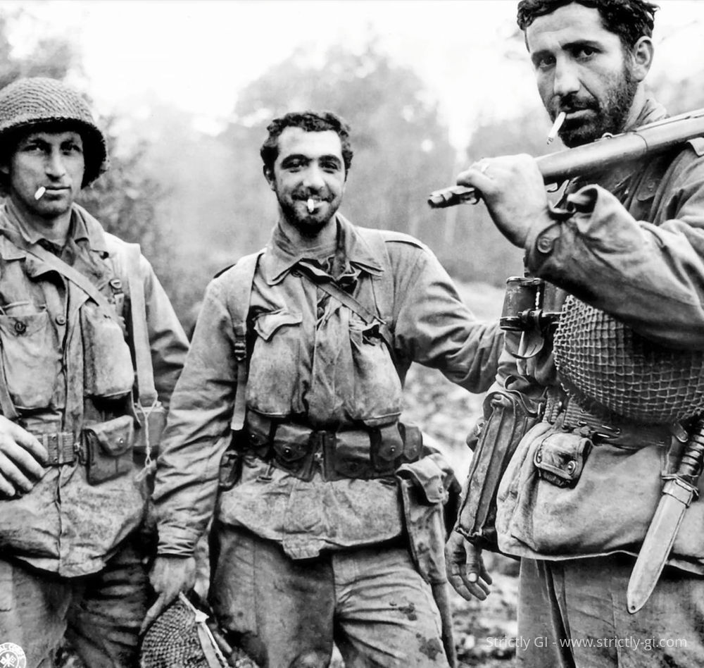 Soldiers of the 79th Infantry Division, on their way to a rest camp after being relived from combat near Laneuveville, France.

Left to right: Private First Class Arthur Henry Muth, Sergeant Carmine Robert Sileo and Sergeant Kelly C. Lasalle.