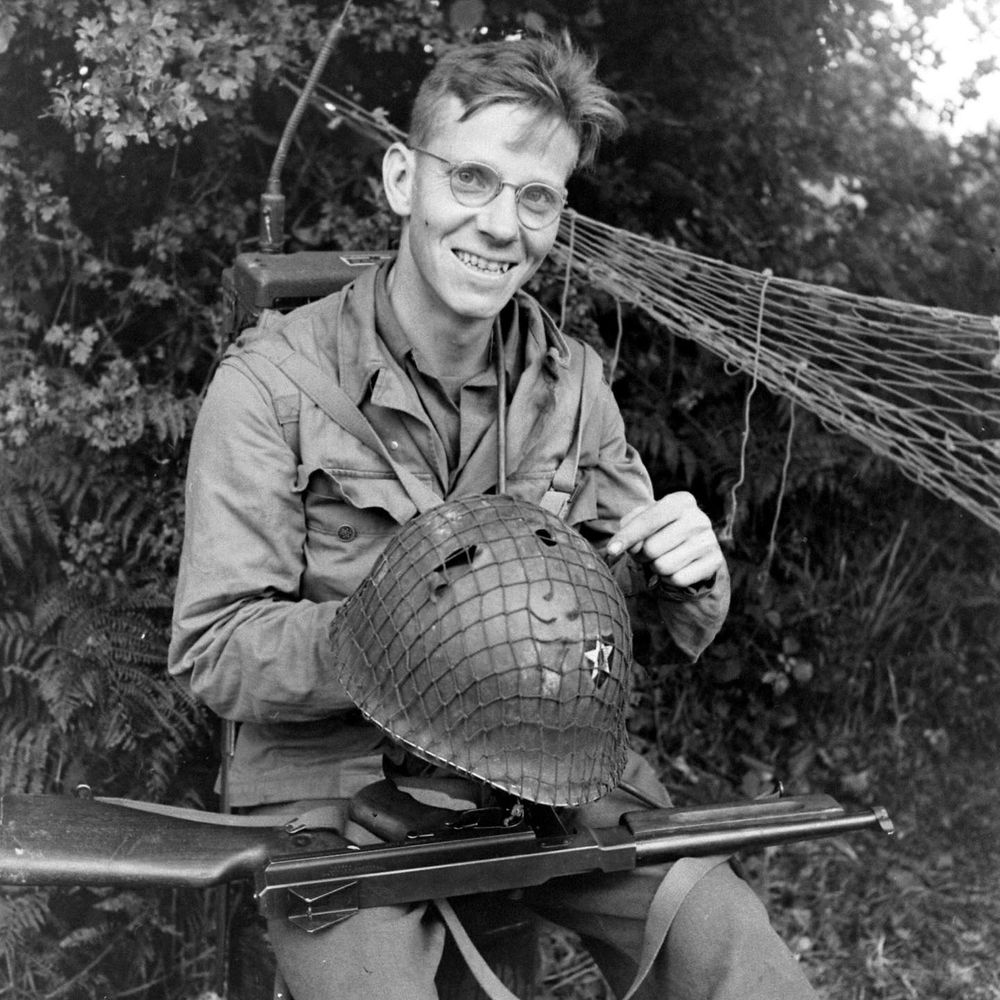 T/Sgt Meredith J. Roger (San Antonia, Texas) of the 2nd Infantry Division, proudly shows off his lucky escape. Photograph taken near Cherbourg.