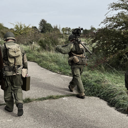 The M1917A1 water-cooled machine gun team head inland from the beachhead. 