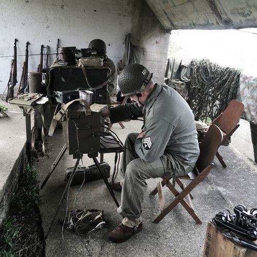 The Company Clerk is hard at work inside the Command Post operating a 6-line telephone exchange with units closer to the frontlines. 