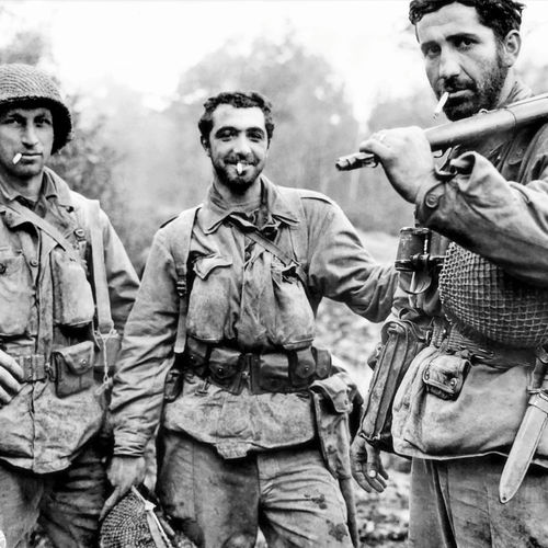 Soldiers of the 79th Infantry Division, on their way to a rest camp after being relived from combat near Laneuveville, France.

Left to right: Private First Class Arthur Henry Muth, Sergeant Carmine Robert Sileo and Sergeant Kelly C. Lasalle.