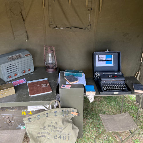 Inside the clerk's office, showing an MD4 Chest, complete with typewriter table, US Army Morale Radio and various paperwork items.