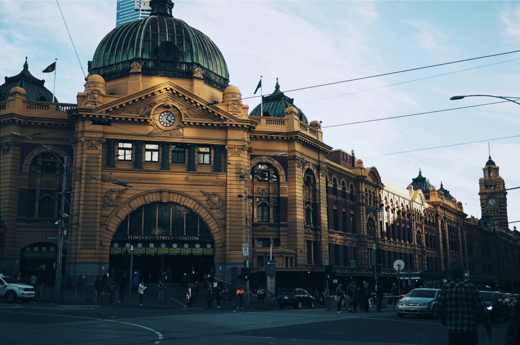 brown building with cars passing infront