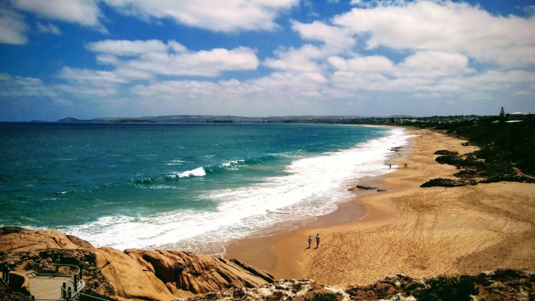 brown sand beach under blue sky and white clouds during daytime