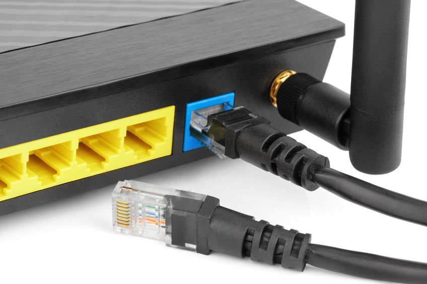 19660612 – closeup of network cables connected to wifi router on white