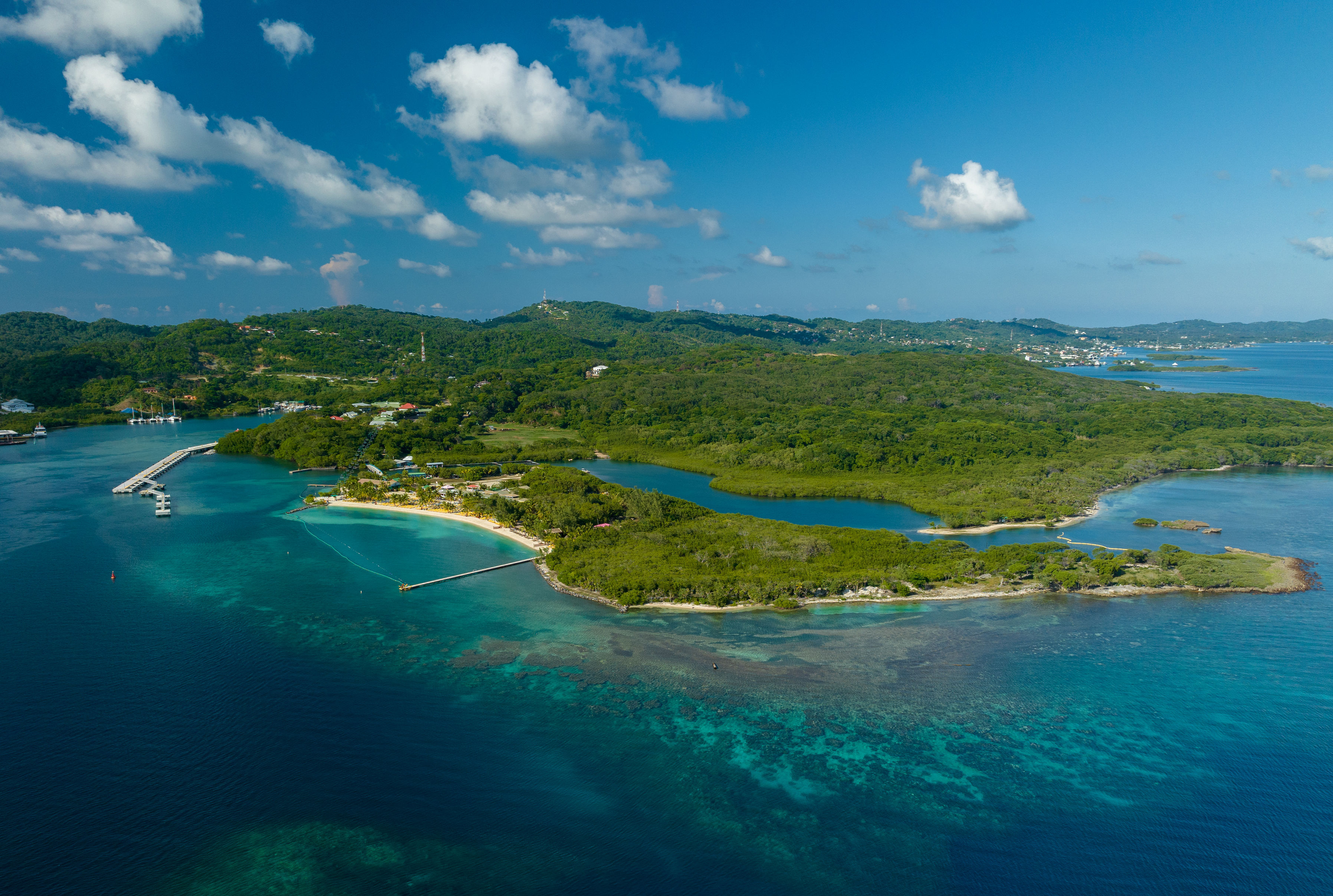 Western Caribbean cruise destination featuring Roatan, Honduras, turquoise water, reef, and island coastline