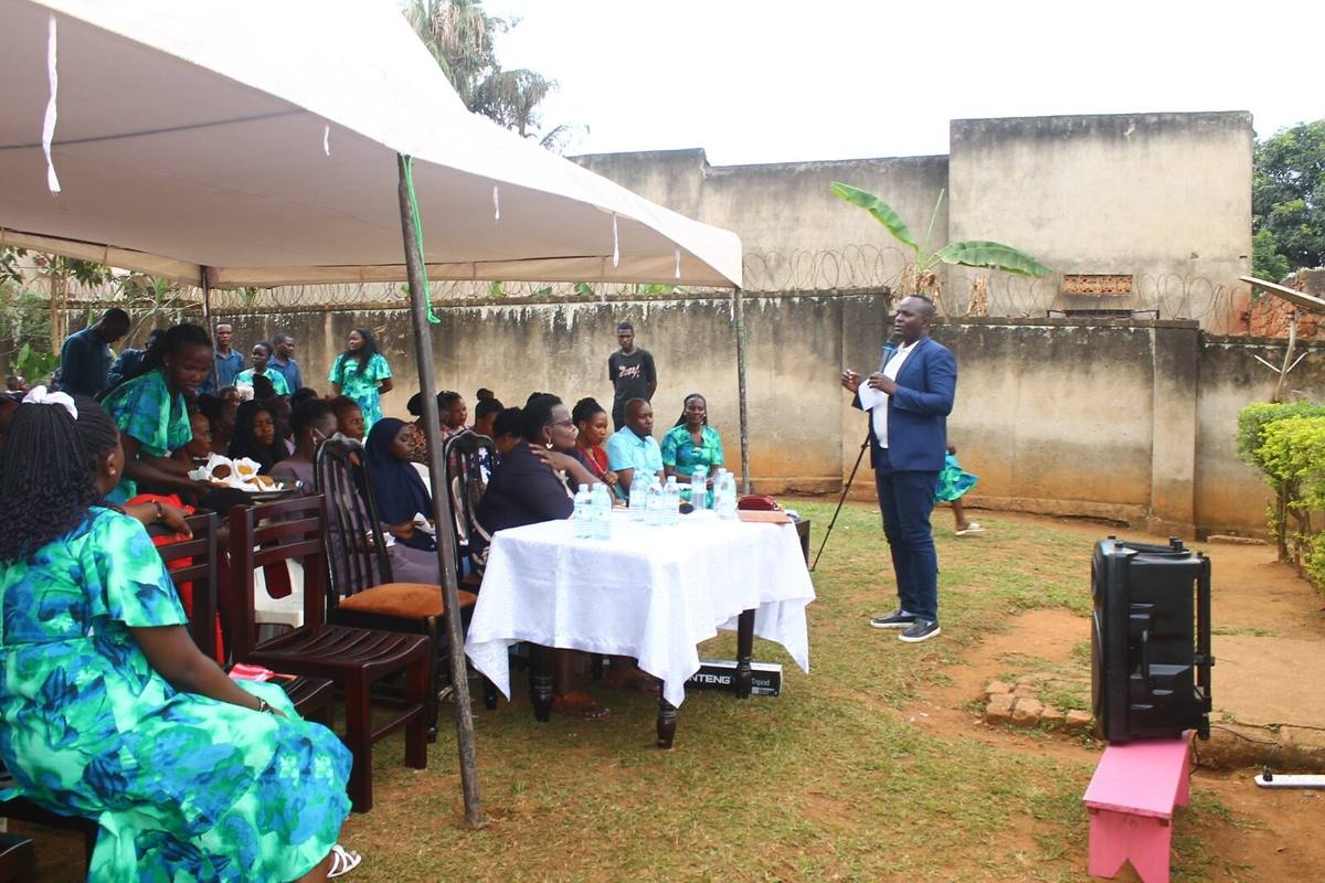 A speaker addressing the parents’ meeting beside the head table