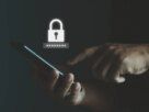 Man holding phone with password security lock icon