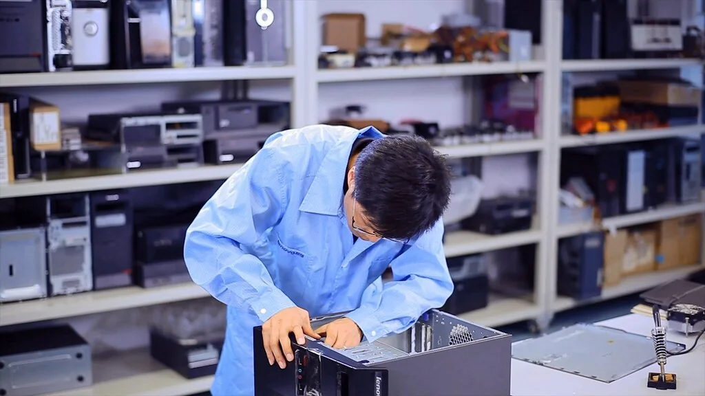 A person works at a desktop computer.