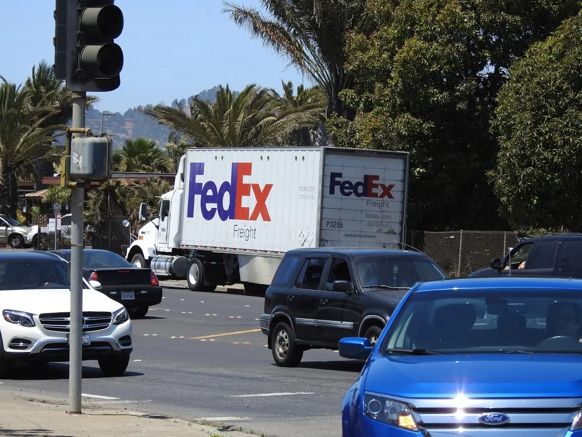 A FedEx delivery truck on a city street.