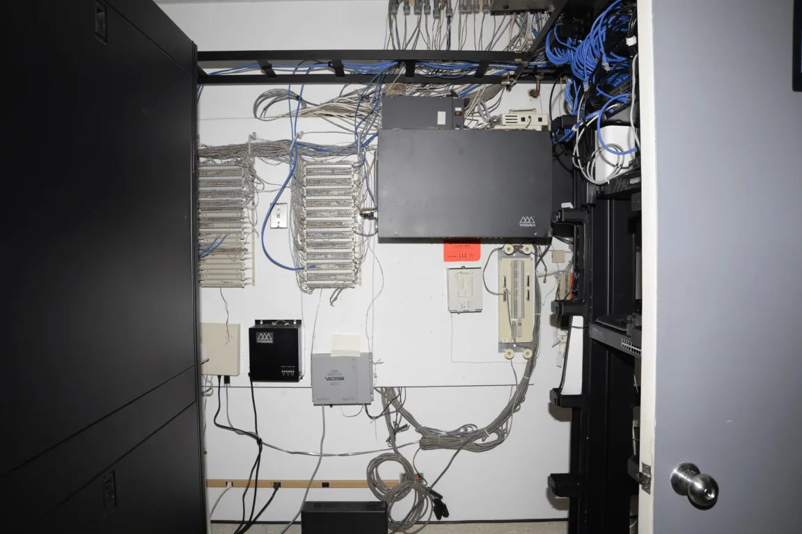Rows of rack-mounted servers and network equipment in a computer room.