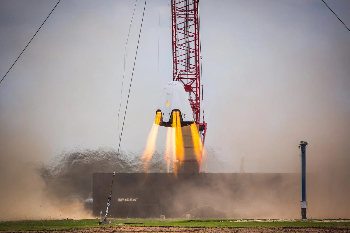 A full-size SpaceX Dragon test article during a hover test.