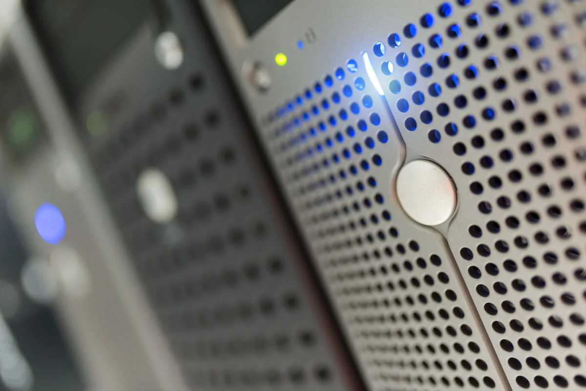 Blue and green status lights glow across a close-up of server hardware.