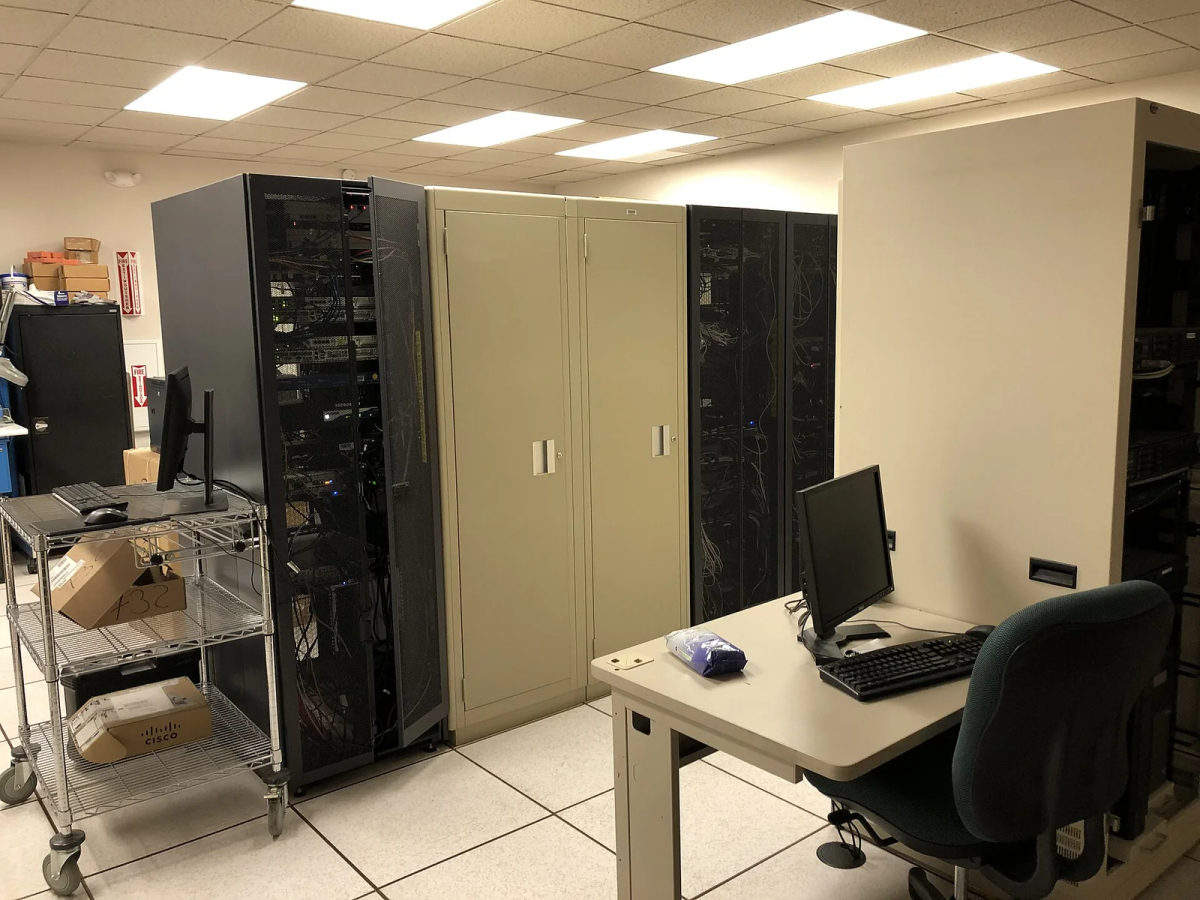Rows of rack-mounted servers and network equipment in a computer room.