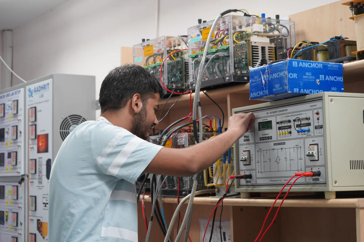 An engineer works with electronic equipment in a research laboratory in India.